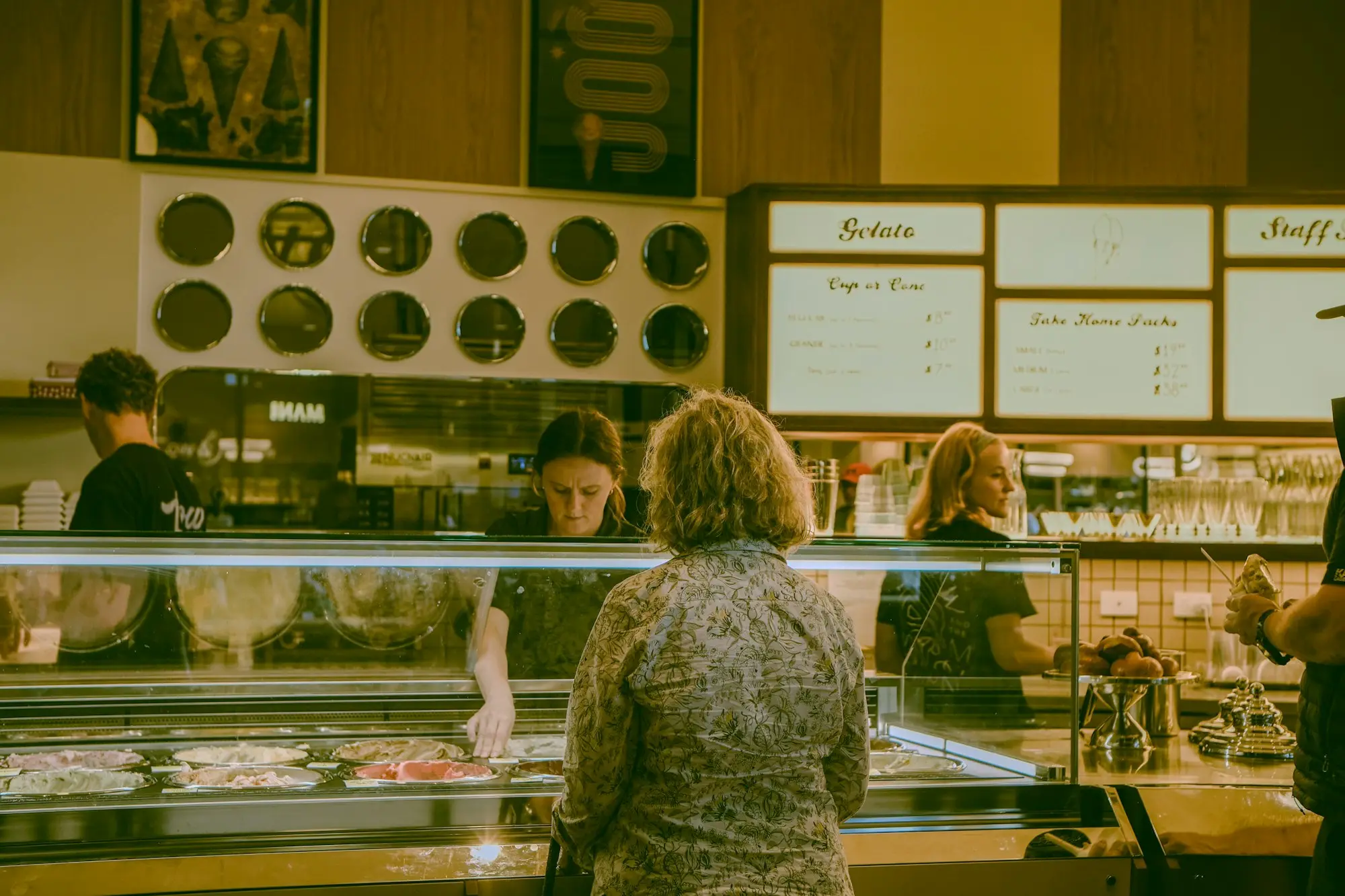 Customers being served at a busy deli and gelato counter in Adelaide