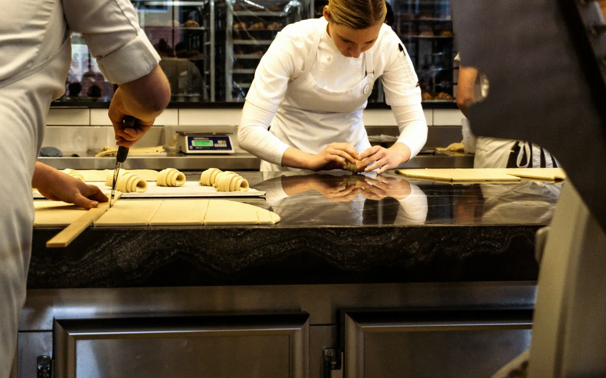 Chefs preparing pastries in a busy Melbourne restaurant kitchen