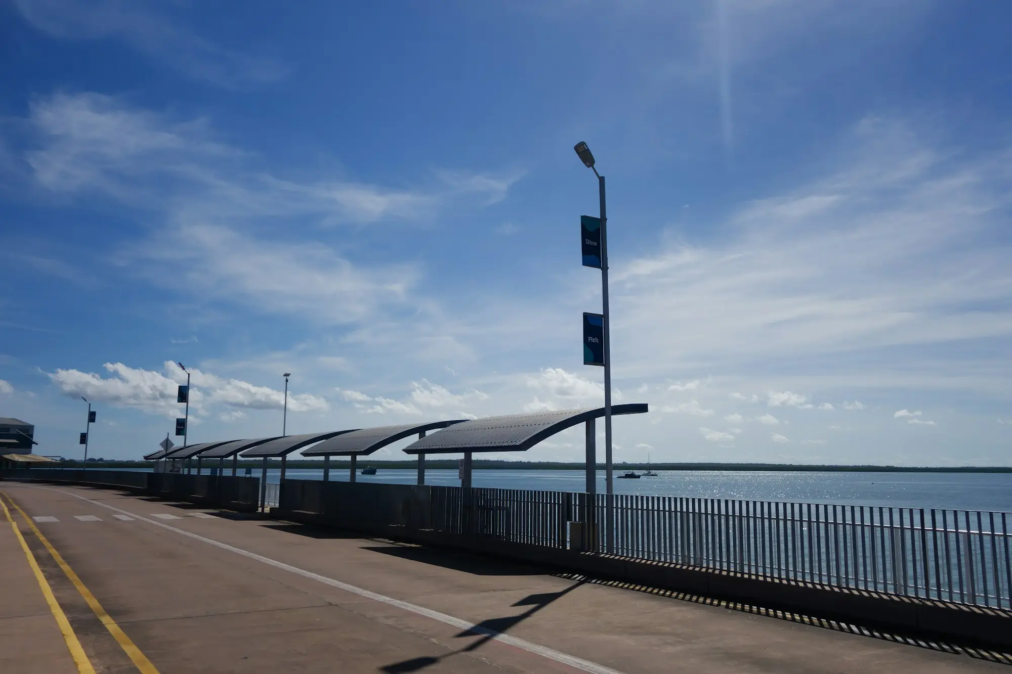 Shade shelters along the Darwin waterfront path under a big blue sky