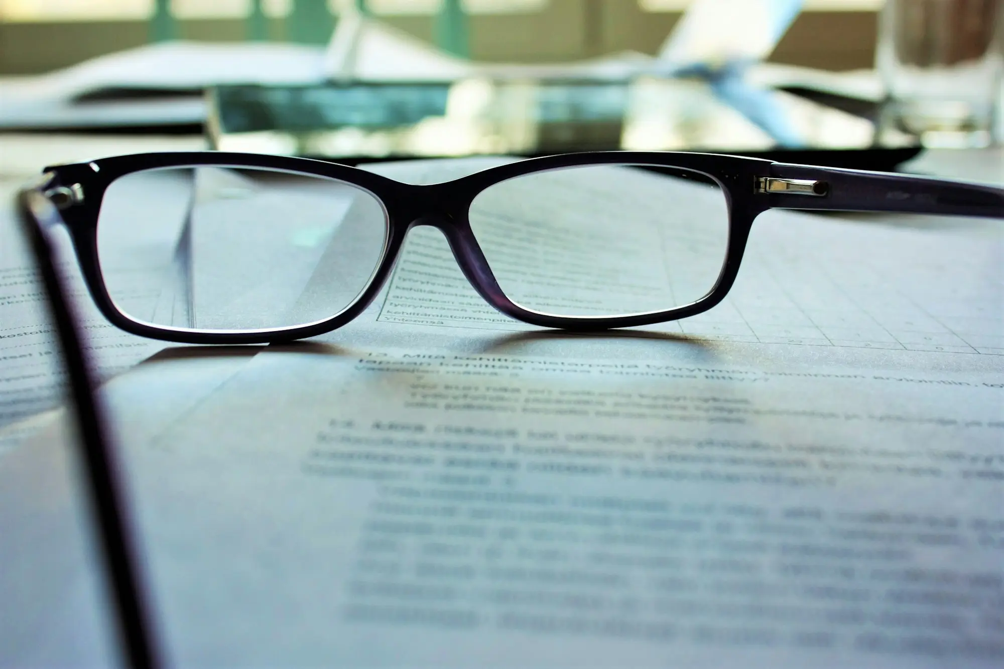 Reading glasses resting on a printed loan offer document
