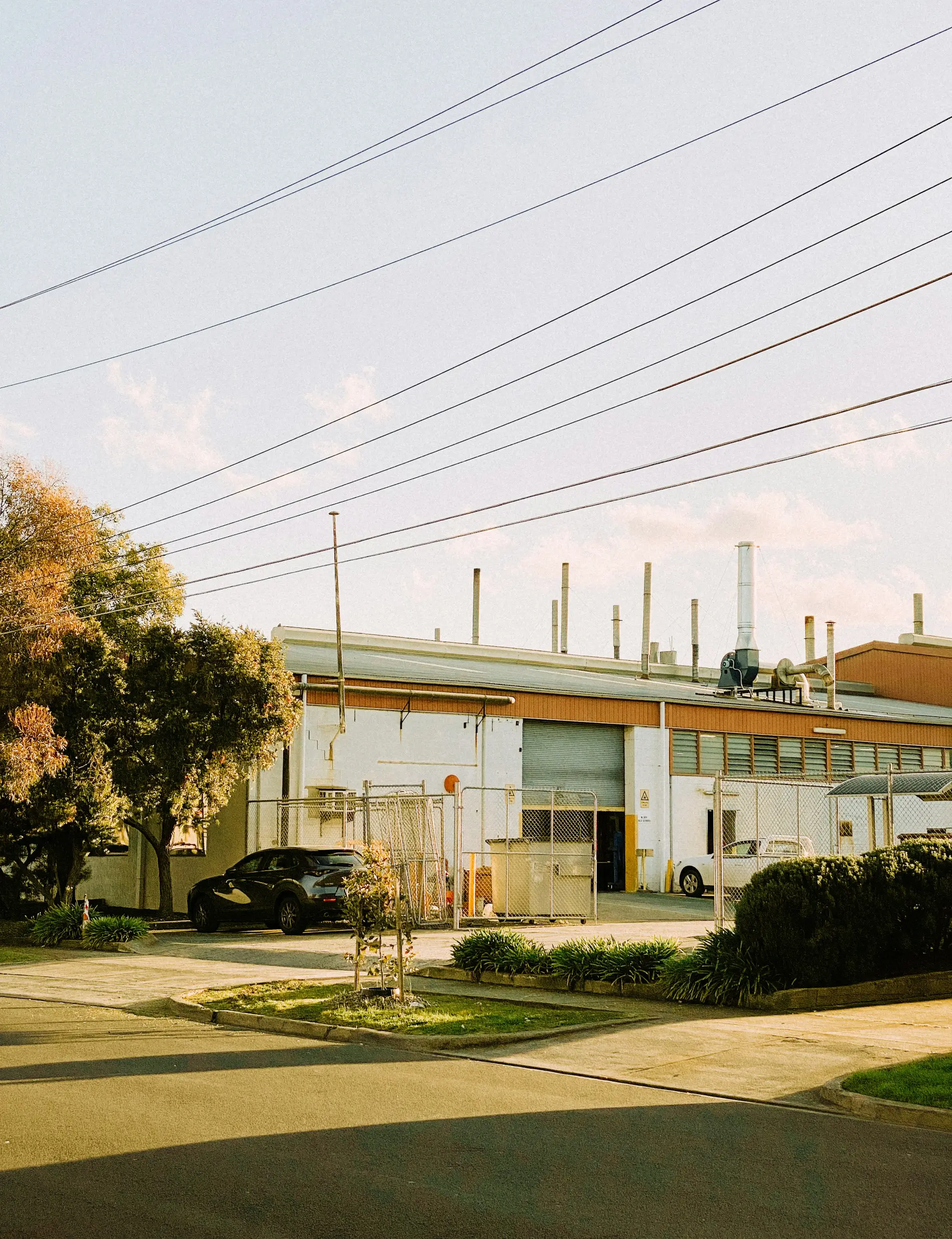 Factory unit with a roller door and fenced yard in Melbourne's north