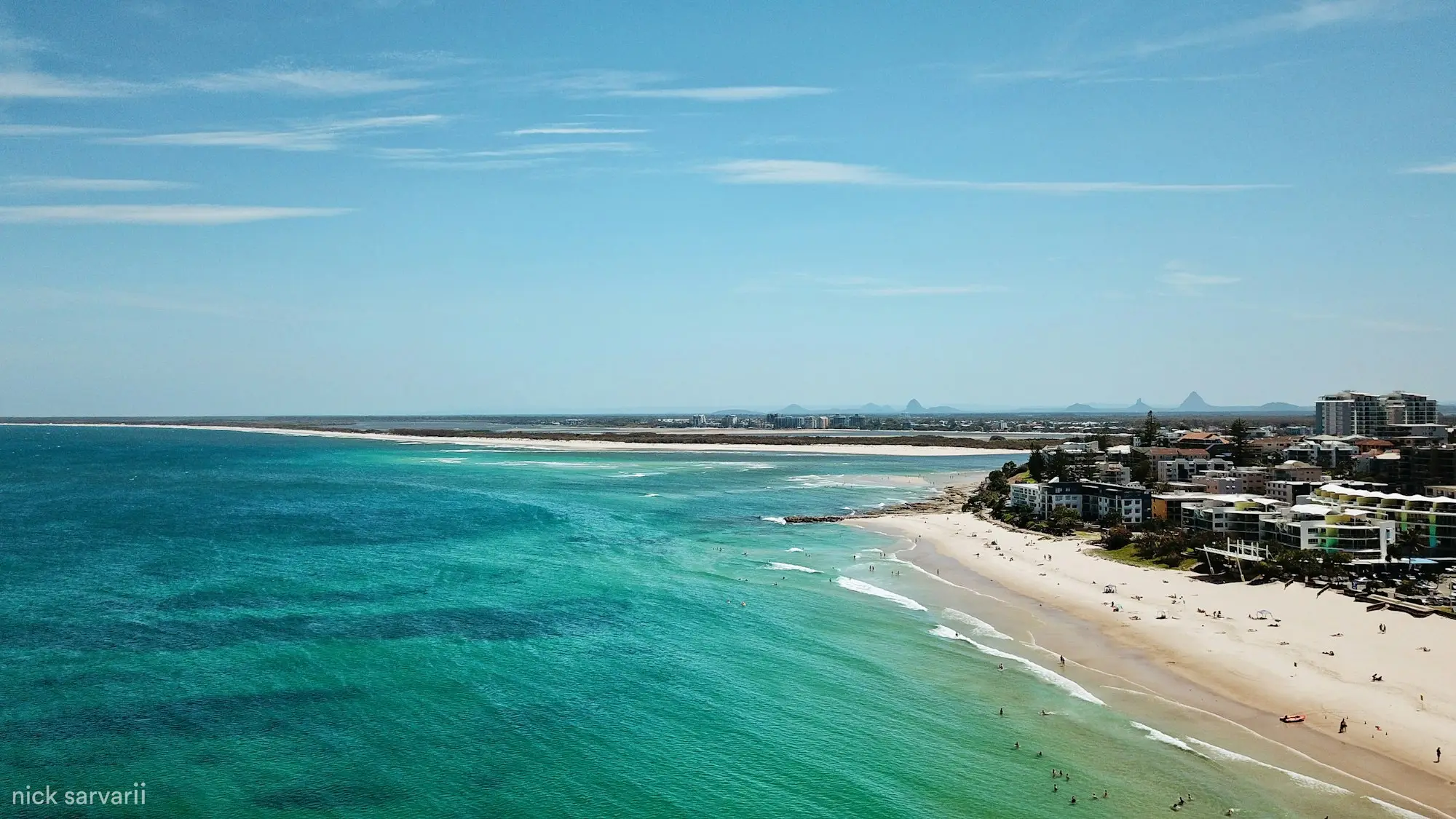 Aerial view of a Sunshine Coast surf beach meeting turquoise water