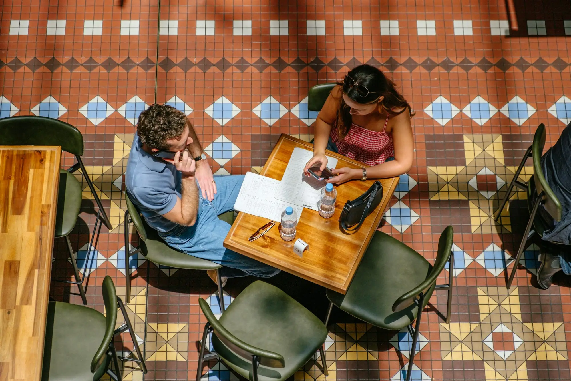 Two business partners going through paperwork at a Sydney cafe table